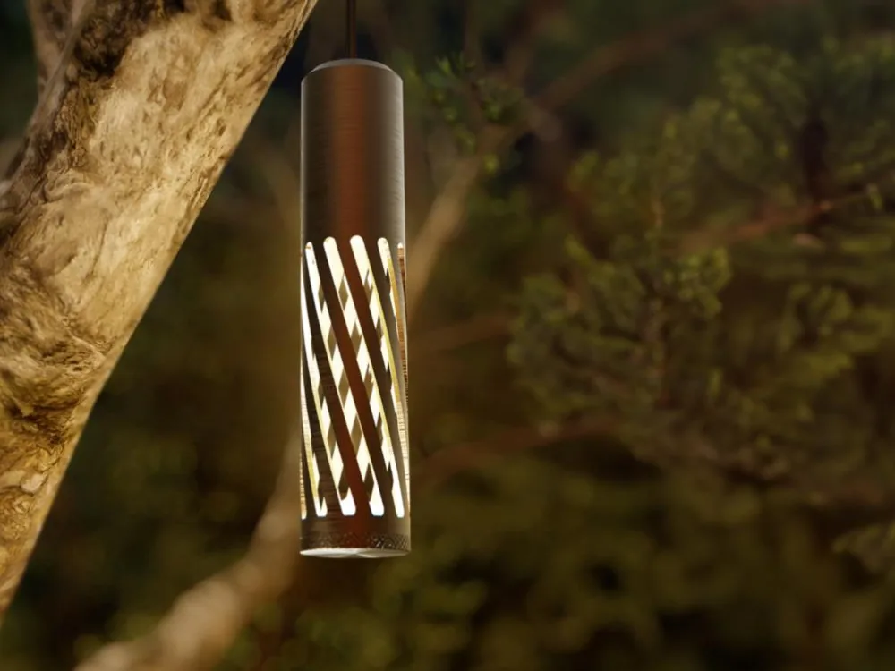 A Coastal Source EVO pendant fixture hanging from a tree branch