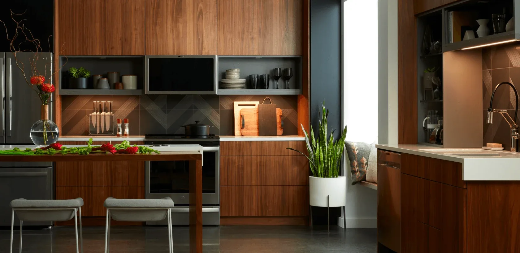 A walnut kitchen at dusk with Savant under-cabinet and shelf lighting on