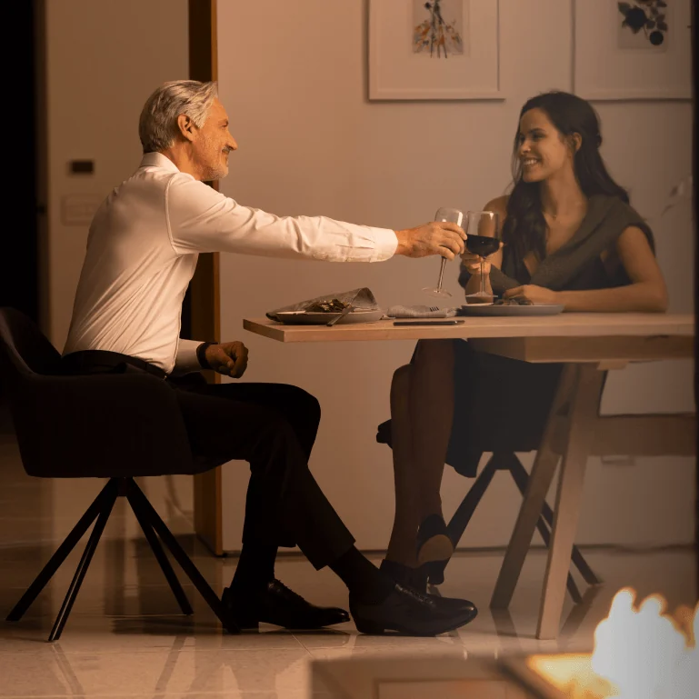 Layered lighting over a kitchen and dining table in the evening